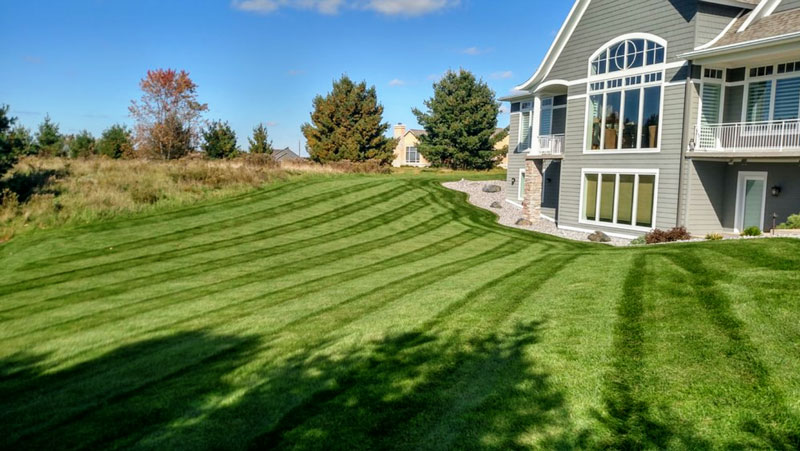 a house with a large lawn in front of it